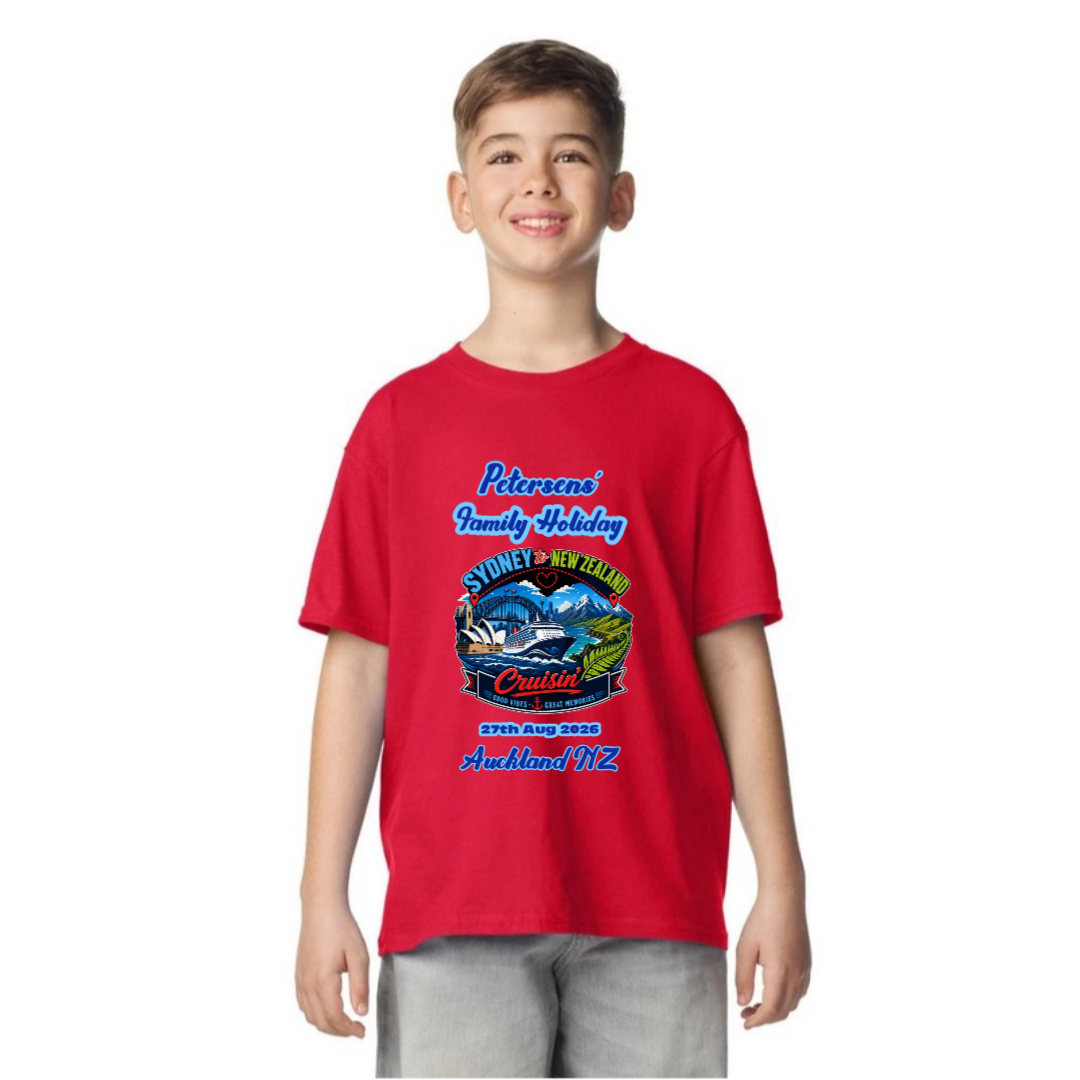 Young boy wearing a personalised red Gildan 64000B Youth Tee with front print for a Sydney to New Zealand cruise, featuring family name, cruise date and New Zealand destination.