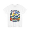White t-shirt with a colorful graphic design featuring a cruise ship, palm trees, and text on a white background.