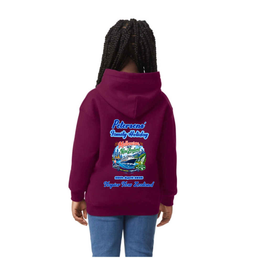 A child shown from the back wearing a maroon Gildan® Heavy Blend® 18500B Hoodie with a colorful 'Pikemans Family Holiday Whanganui New Zealand' graphic on the back, paired with blue jeans, against a plain white background.