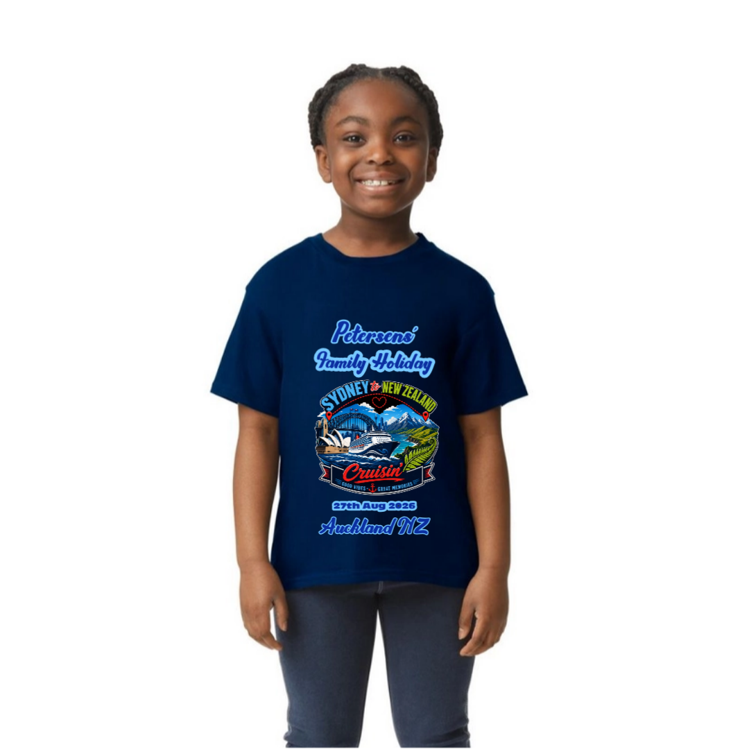 Young girl wearing a personalised navy Gildan 64000B Youth Tee with front print for a Sydney to New Zealand cruise, featuring family name, cruise date and Auckland NZ destination.